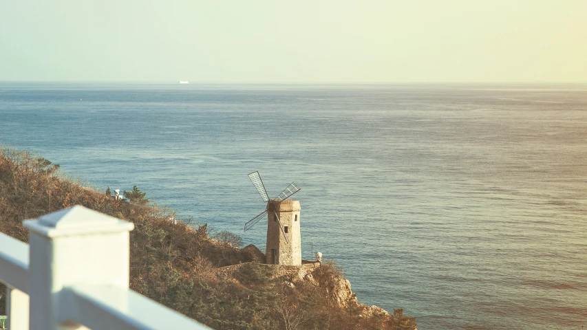 a lighthouse on the side of a cliff near the ocean