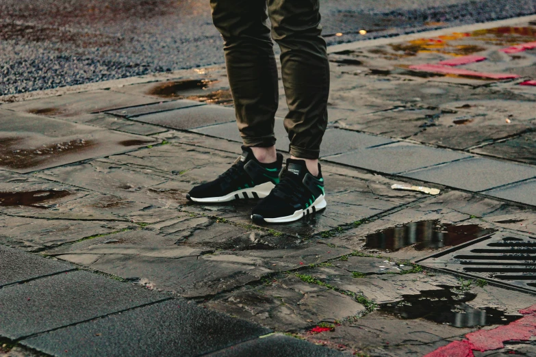 a person stands in the middle of a street with his shoes on