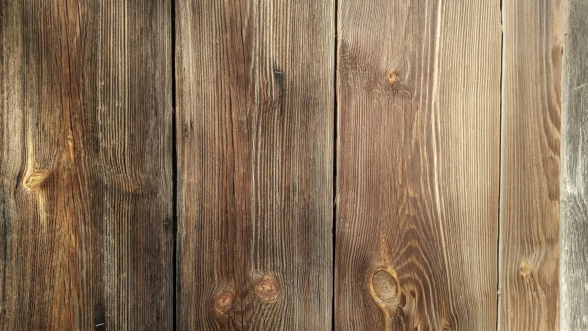 an old wood wall with some brown and white paint