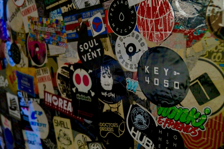 various stickers and tags on a wall