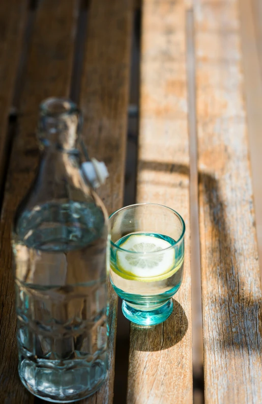 a s of alcohol and glass sitting on a wooden table