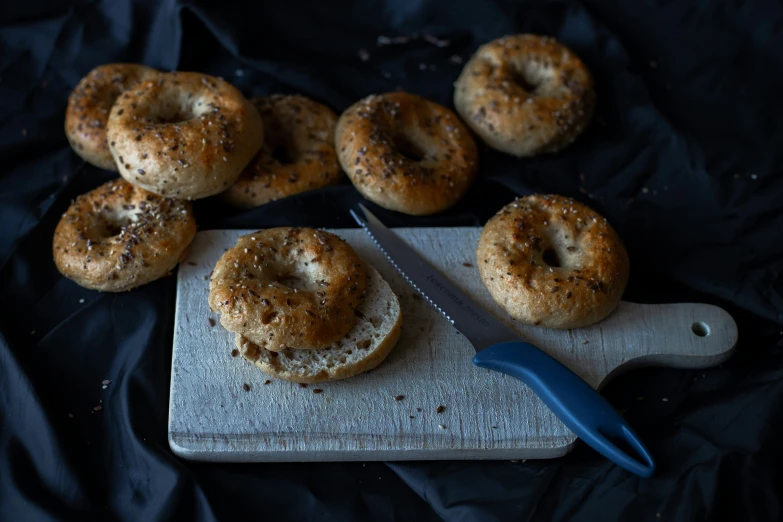 a table topped with bread covered in soing next to a knife