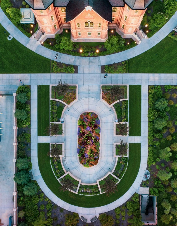 a large house sits in the middle of a garden