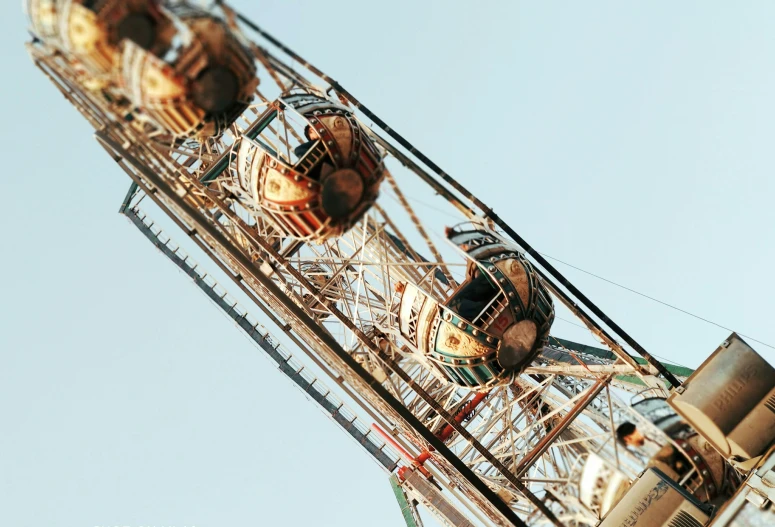 the front side of an amut ferris wheel against a blue sky