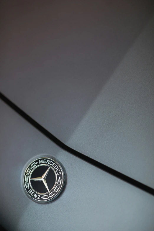 the emblem on a metallic mercedes car