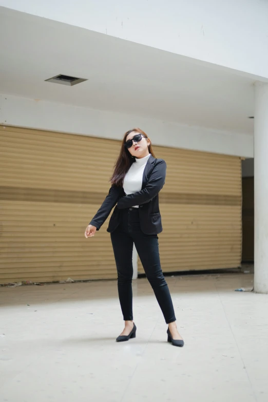 a woman standing on top of a concrete floor