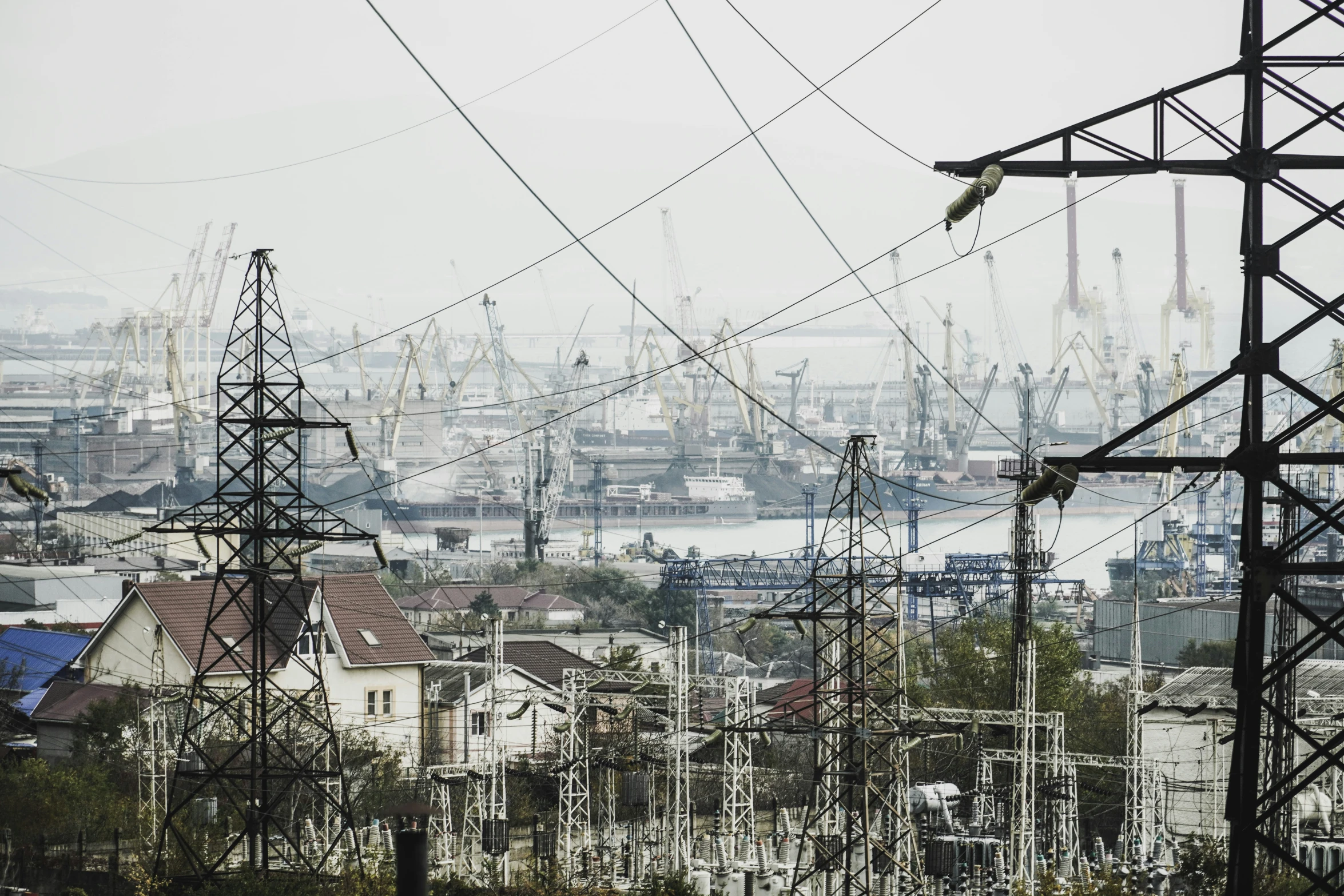 power lines run across the horizon in a town