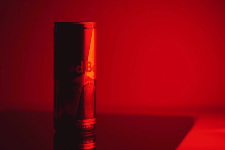 a red light shines down on a red tin