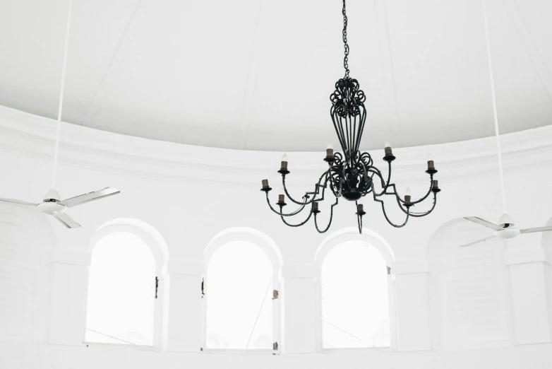 a chandelier hangs from the ceiling in a large room