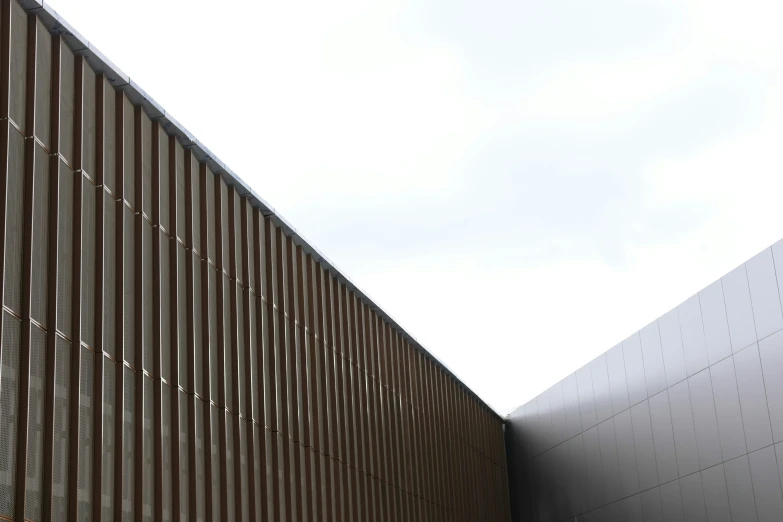 the side of a building has an elegant wooden fence