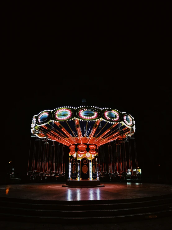 a merry go round at night with the lights on