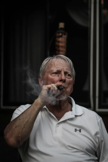 a man in white shirt smoking a cigarette