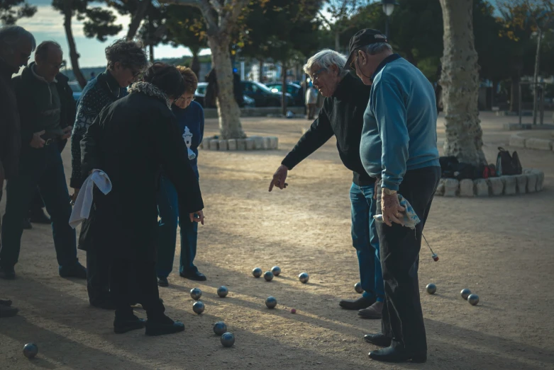 people play a game of goblets on a city street