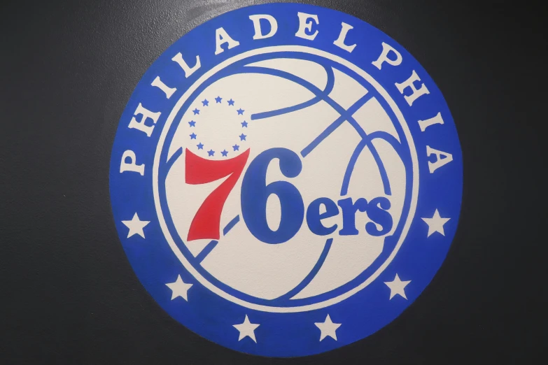 the philadelphia 76ers'logo is a round sign with blue and red stars