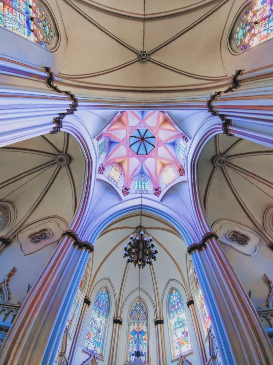 the inside of an empty church with stained glass windows