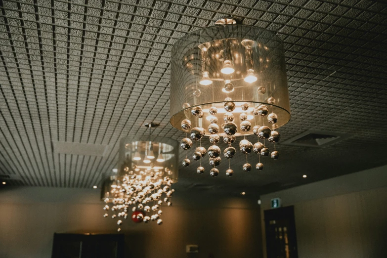 an empty lobby with chandelier and a mirror