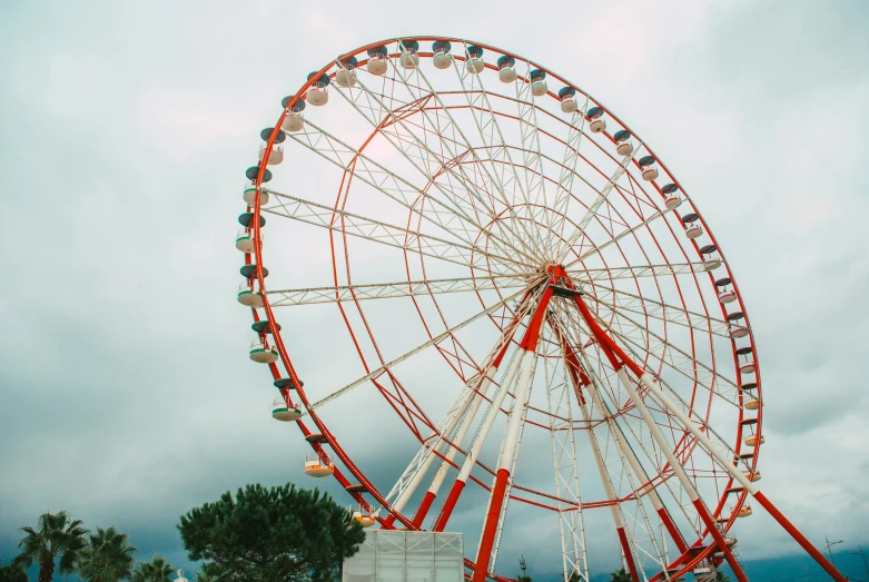 a very large wheel next to some dark clouds