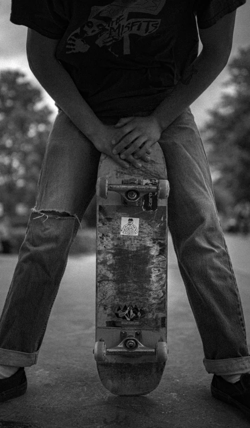 a person is sitting on a skate board