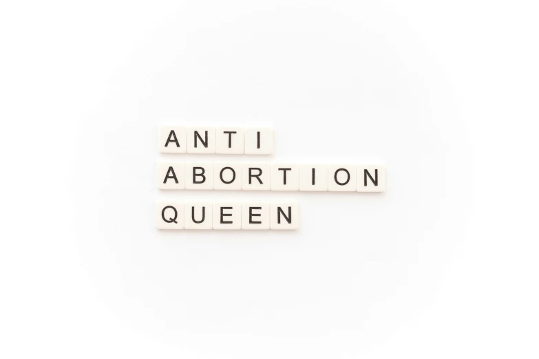 three block words spelling an anti - abortion queen
