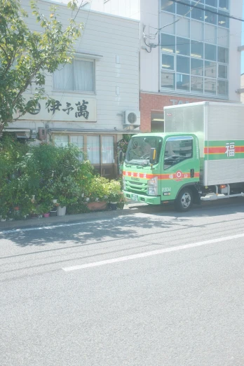 a delivery truck parked in front of an apartment building