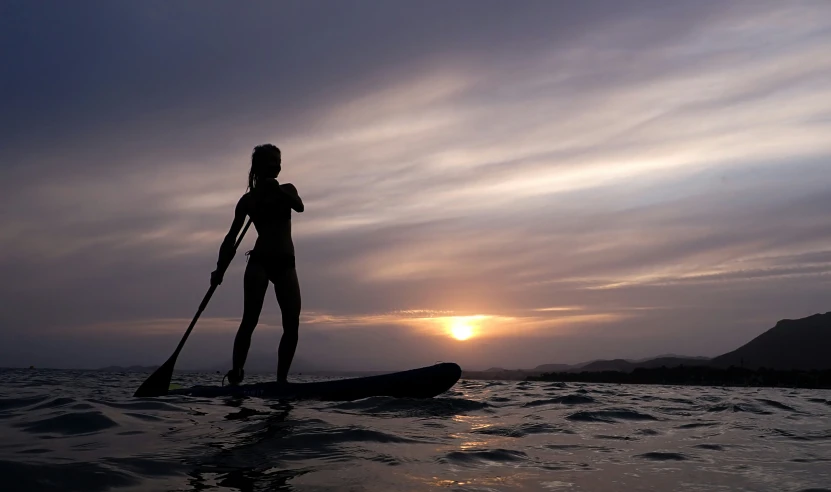 a man that is standing on a surfboard in the water