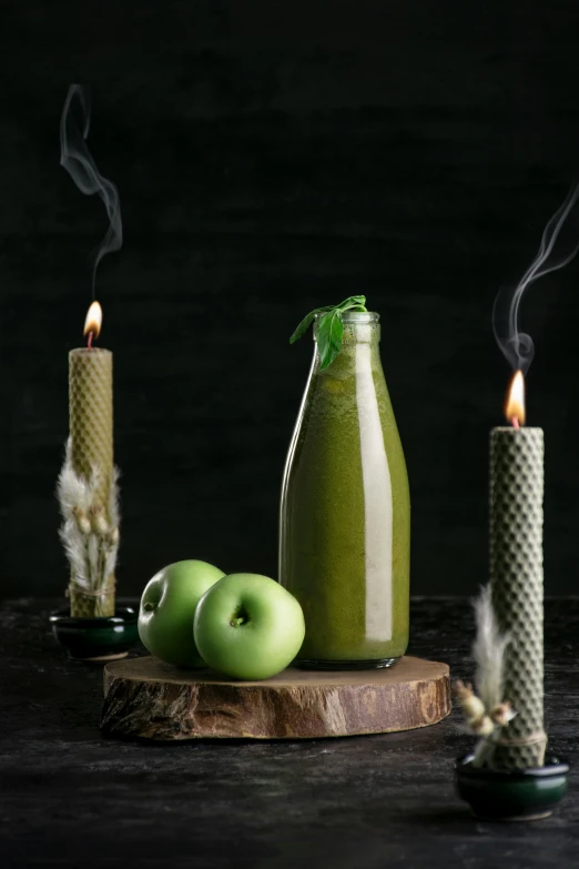 green apple products being used to make candles and candleholders