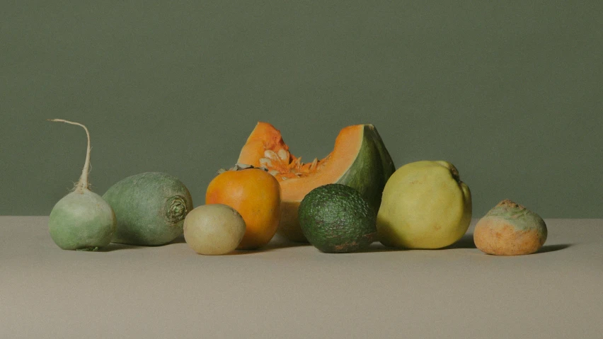 a group of fruit sits in front of green background