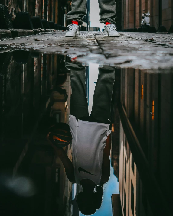 the reflection of a person standing on top of a building