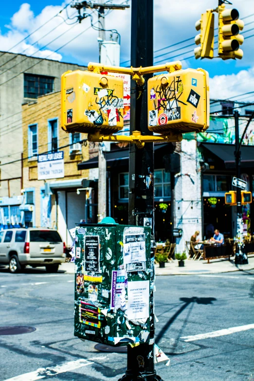 a yellow traffic light sitting below a cross walk sign