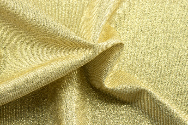 the image shows a texture of fabric with a gold background