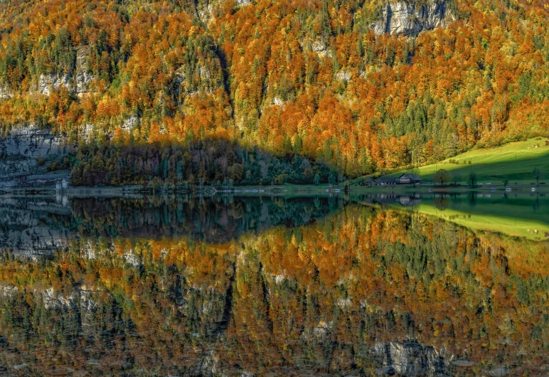 a scenic po of a mountain lake surrounded by autumn foliage