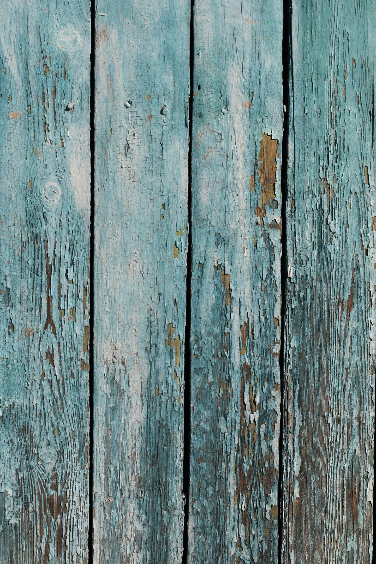 a weathered wood board painted with aqua green