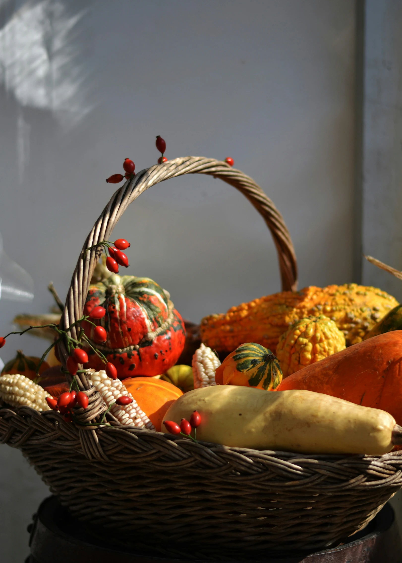 baskets filled with squash and gourds sit on a table