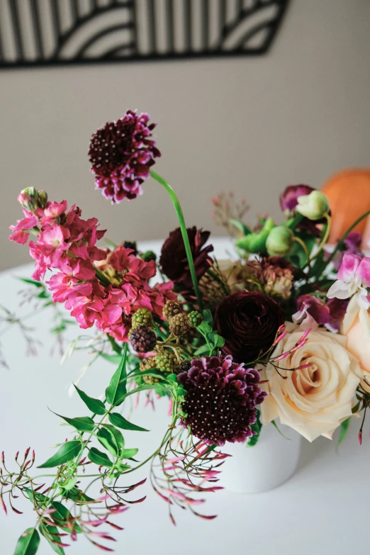 flowers in a white vase on a table