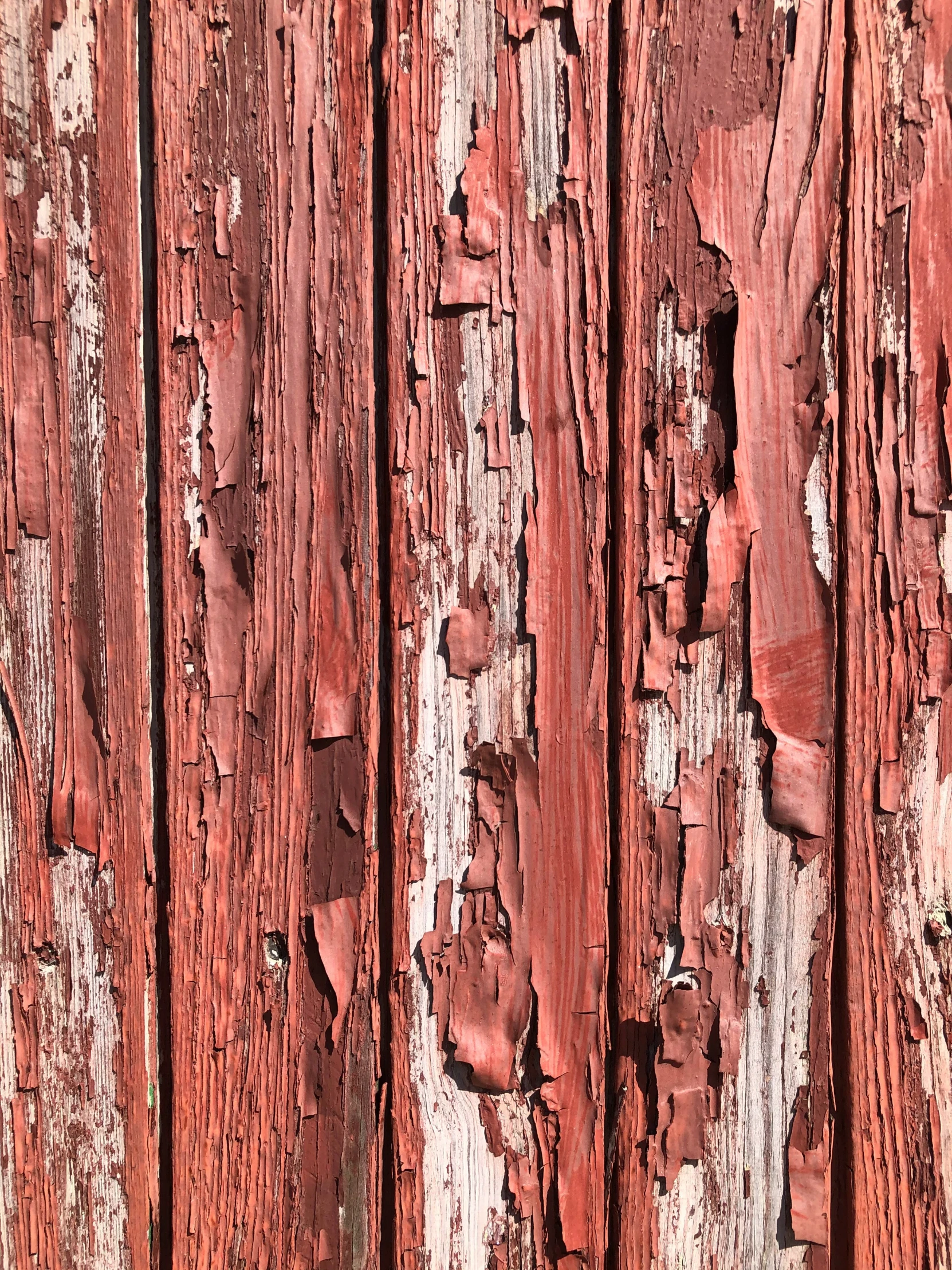 a wooden structure with chipped paint on the sides