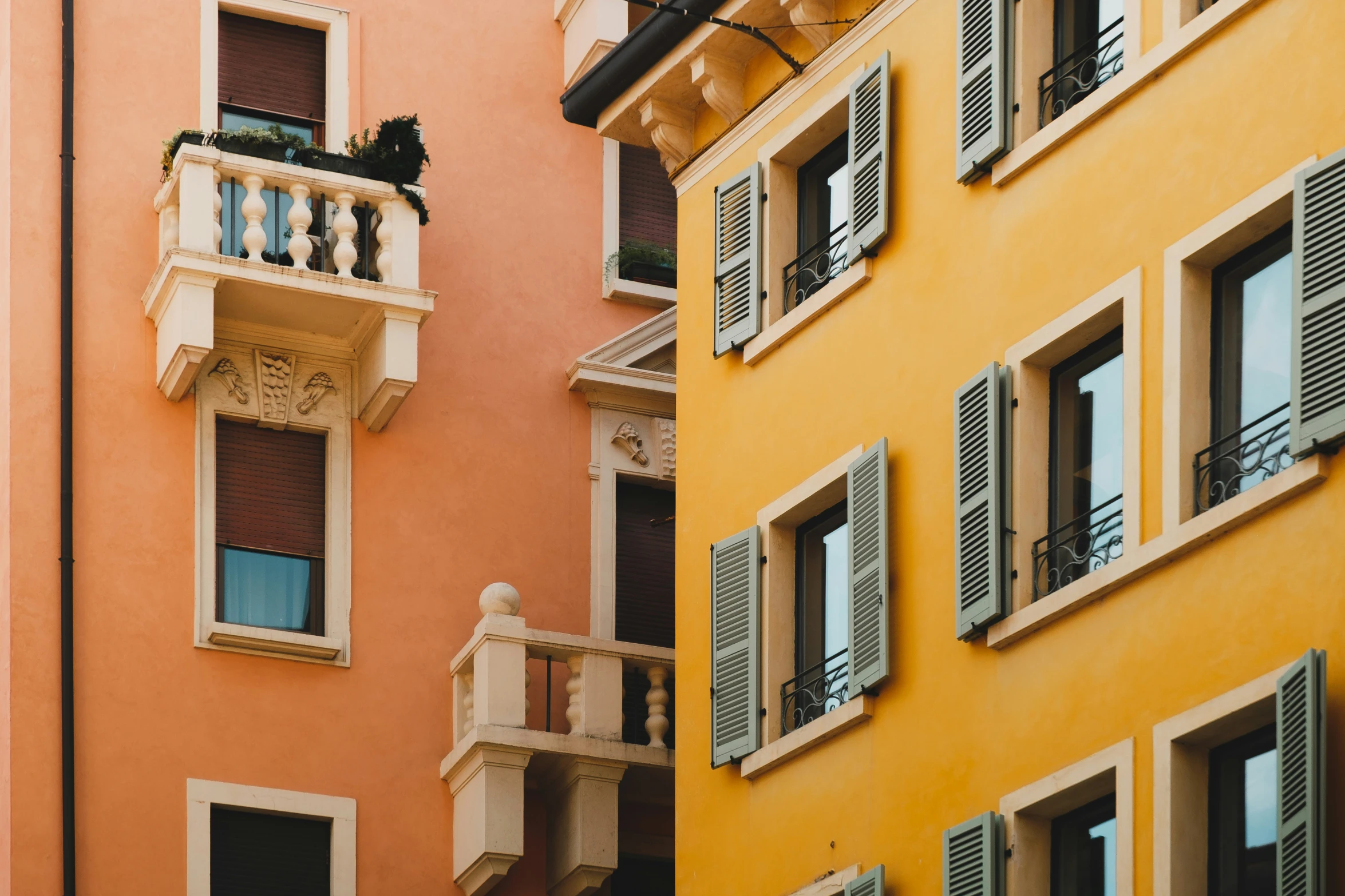 tall buildings with many windows, balconies and shutters