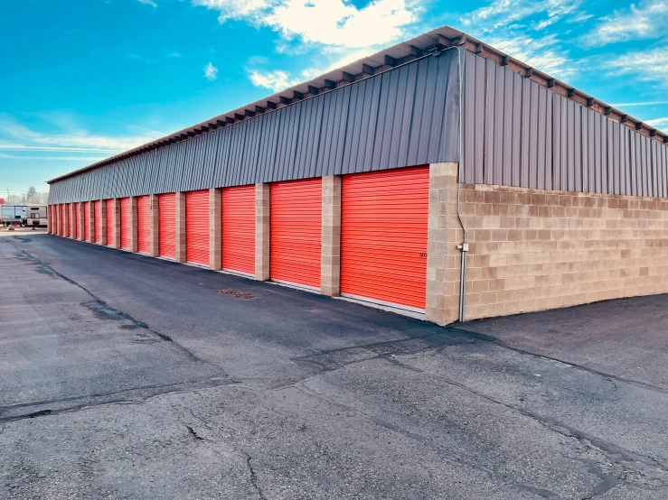an empty storage building with red doors and no door handles