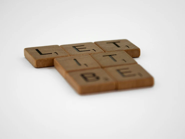 three brown tiles with some type of words on them