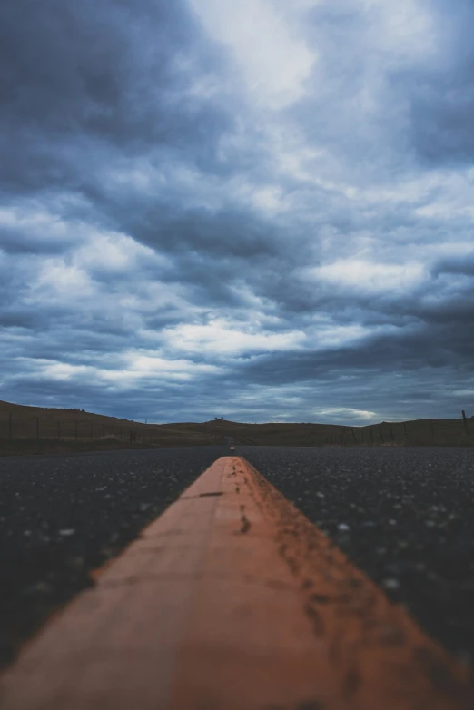 an empty road stretches into a distant sky