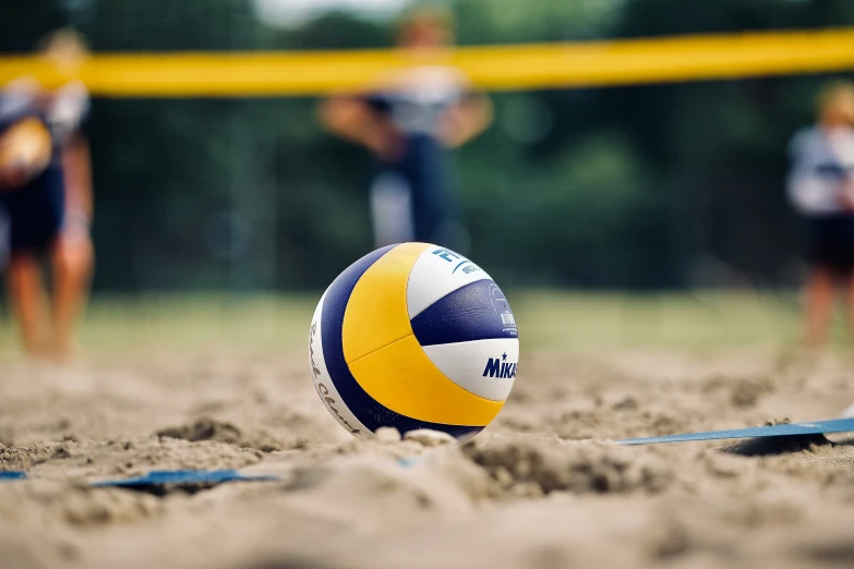 a volley ball sits in the middle of a group of volleyball players