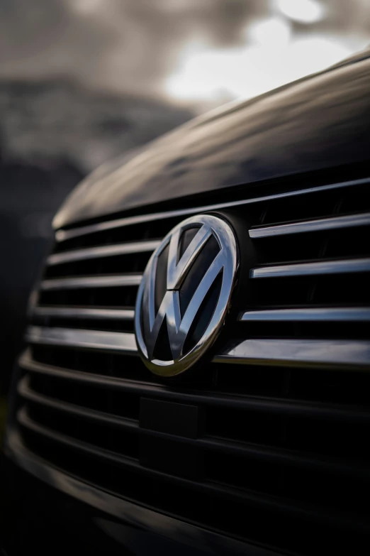 the front grille of a volkswagen vehicle in the dark