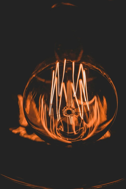 light painting a glass bowl on black with flames