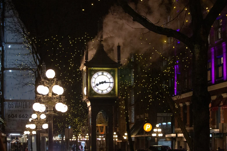 a clock tower with lights above it in the dark