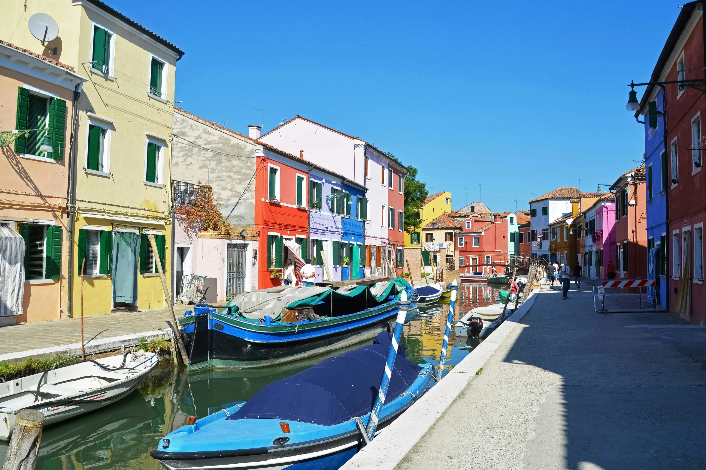 boats moored near some buildings and water