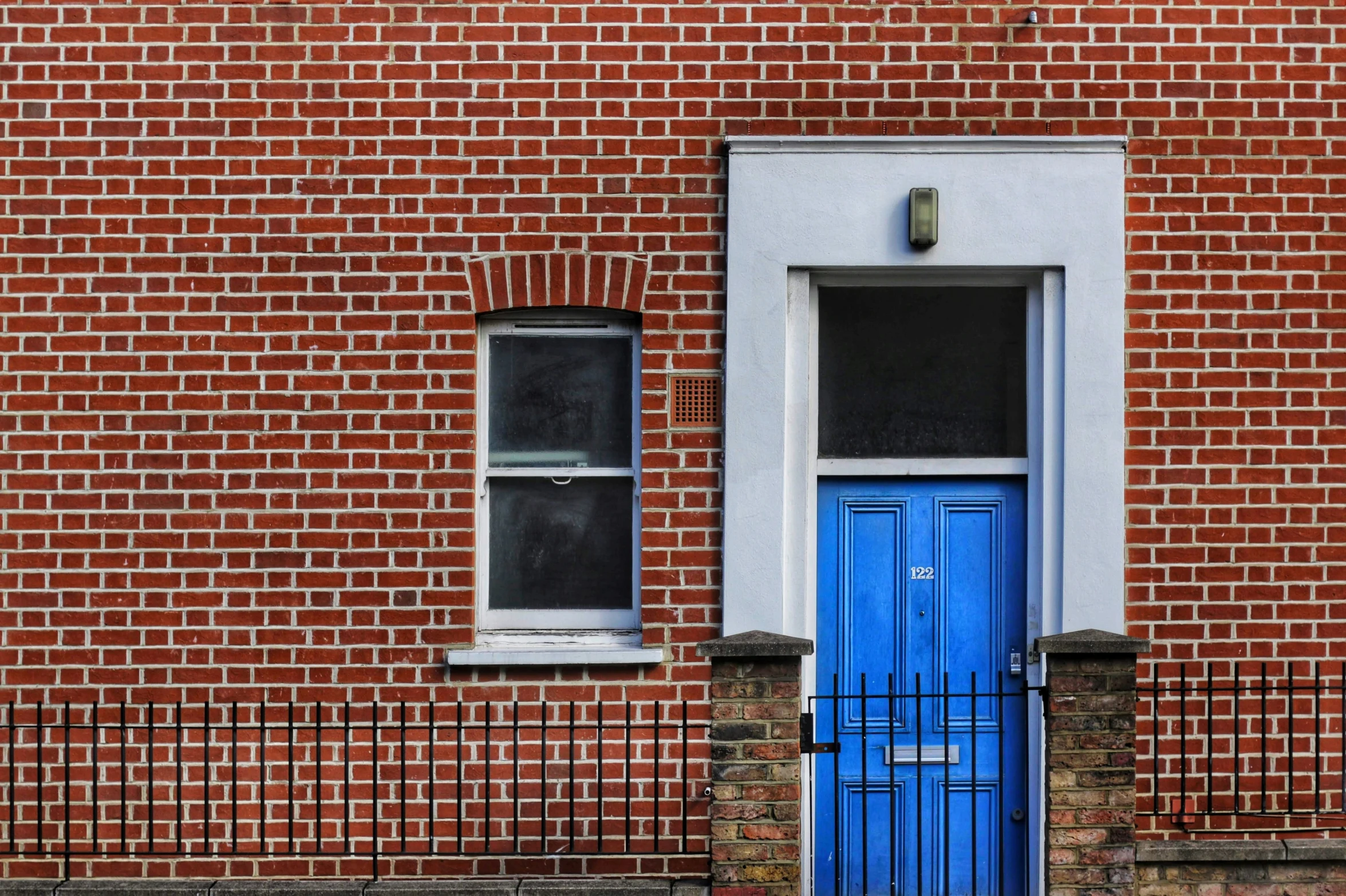 a blue door and brick building in the city