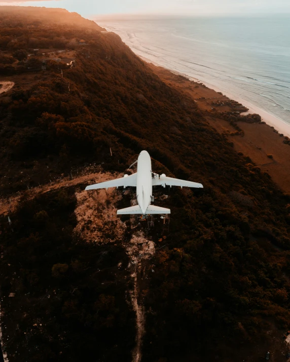 a military style plane flying over water and land