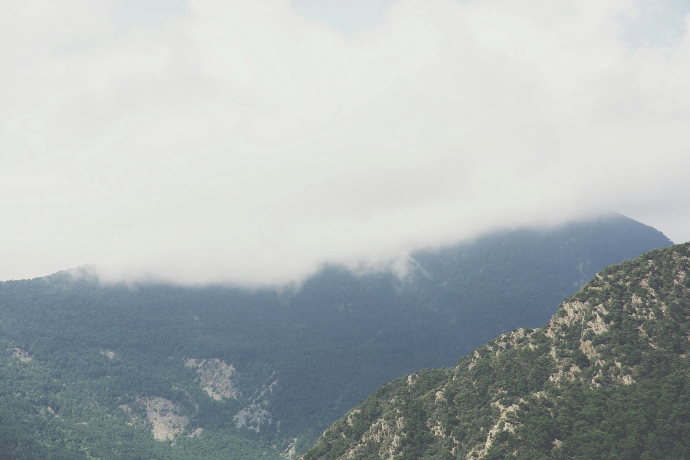 a po of a mountain with a few clouds