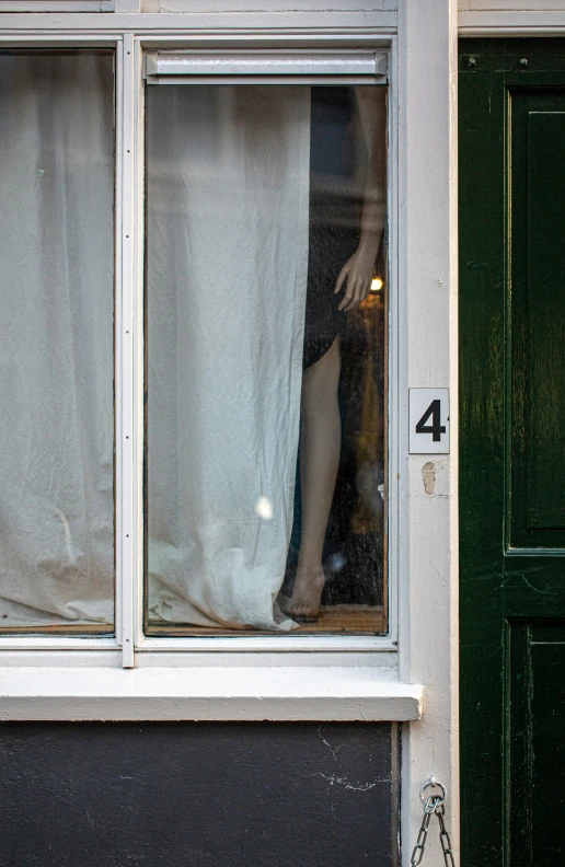 the window is closed in front of the curtain