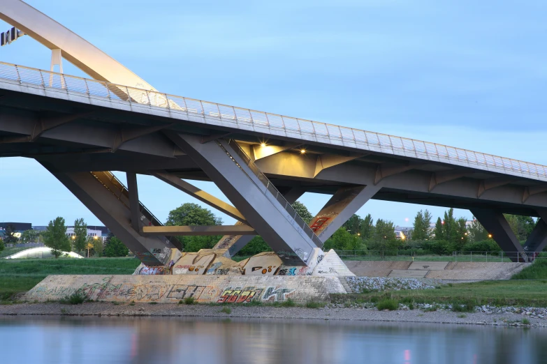 a bridge is open at night by the water