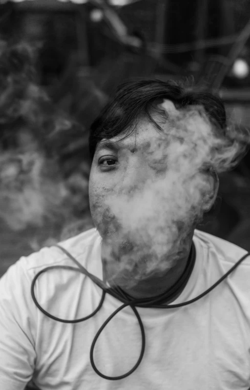 a man with an odd face standing in front of smoke